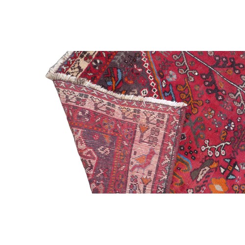 422 - A Hamadan rug, with red ground and floral decoration, 280 by 193cm.