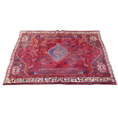 422 - A Hamadan rug, with red ground and floral decoration, 280 by 193cm.