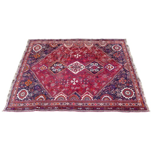 424 - A Hamadan rug, with red ground and floral decoration, 303 by 220cm.