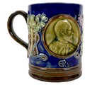 A Royal Doulton stoneware Royal Commemorative mug, circa 1901, decorated in Art Nouveau taste with a... 