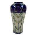 A Royal Doulton stoneware slip cast vase, circa 1912, decorated with stylised tall purple flowers ag... 
