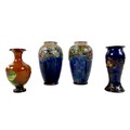 A group of four Doulton Lambeth stoneware vases, comprising a pair decorated with fruit and blue gla... 