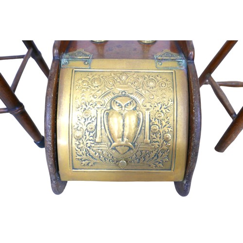 79 - A late Victorian mahogany purdonium / coal scuttle, the embossed brass mounted hinged door decorated... 