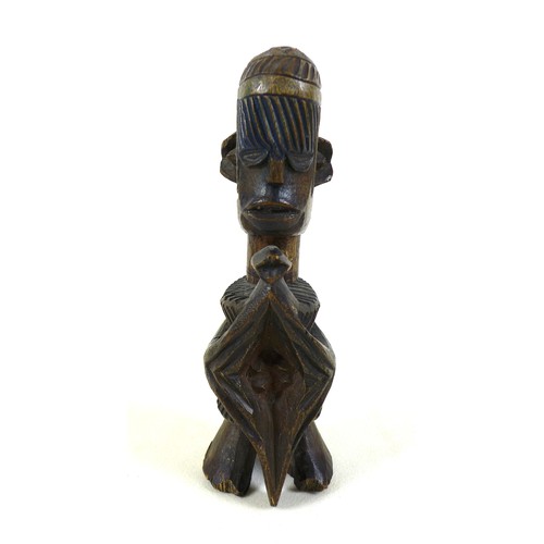 118 - An African carved wooden figure, mid 20th century, with traces of blue and green paint remaining, 20... 