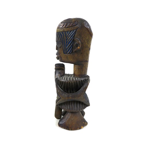 118 - An African carved wooden figure, mid 20th century, with traces of blue and green paint remaining, 20... 