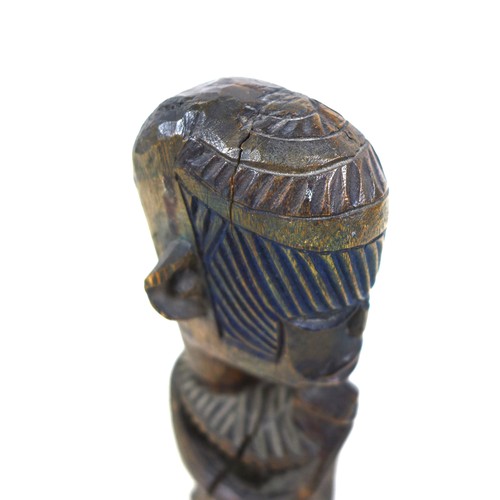 118 - An African carved wooden figure, mid 20th century, with traces of blue and green paint remaining, 20... 