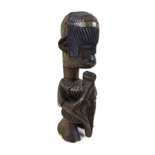 118 - An African carved wooden figure, mid 20th century, with traces of blue and green paint remaining, 20... 