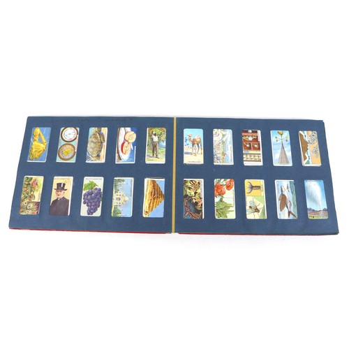 115 - A mid 20th century Will's Cigarette Card Album, red paper bound, containing approximately 150 Will's... 