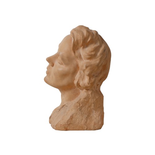 84 - A clay or plaster bust, modelled as a young lady with closed eyes and with head tilted to the left, ... 