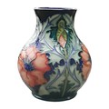 A Moorcroft Poppy pattern baluster vase, with impressed marks to base, 15cm high.