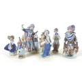 A collection of six Lladro figurines, five modelled as clowns, one as a girl with a basket, together... 