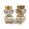 A pair of Japanese Kutani vases, of baluster form, decorated in iron red and gilt, with cartouches o... 