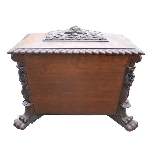 414 - A Victorian mahogany and oak wine cooler of sarcophagus form, with relief carved panels, raised upon... 