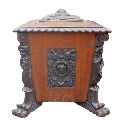 414 - A Victorian mahogany and oak wine cooler of sarcophagus form, with relief carved panels, raised upon... 