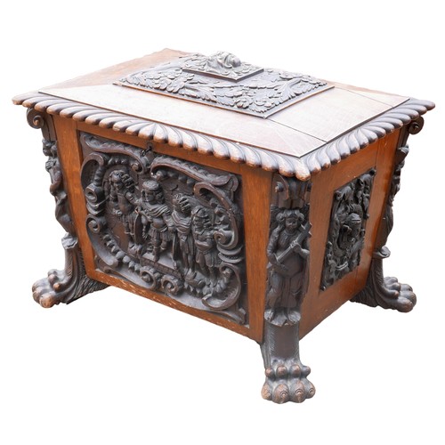 414 - A Victorian mahogany and oak wine cooler of sarcophagus form, with relief carved panels, raised upon... 