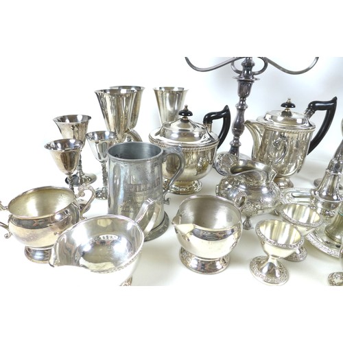 75 - A collection of silver plate and white metal wares, including tankards, goblets, teapots and sugar b... 