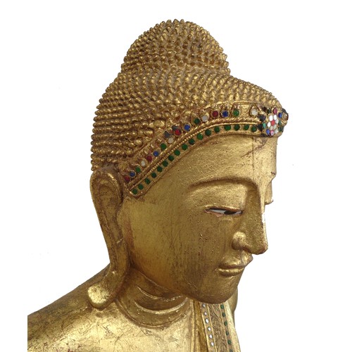 83 - A modern gilt carved wooden sculpture of a Burmese Mandalay Buddha, in standing position with arms o... 