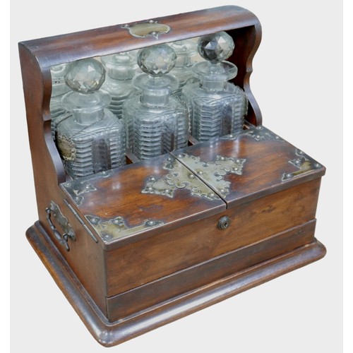 109 - A Victorian tantalus, with three cut glass decanters and silver labels, 38.5 by 29.5 by 32.5cm high.