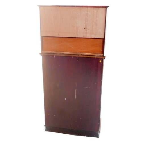 429 - A mid 20th century mahogany dentist's cabinet, with an upper section of twin glazed doors over an op... 