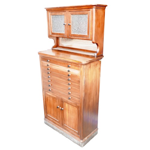 429 - A mid 20th century mahogany dentist's cabinet, with an upper section of twin glazed doors over an op... 