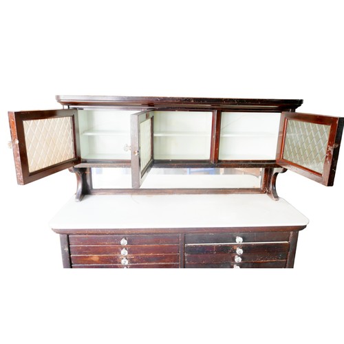 441 - An Edwardian mahogany dentist's cabinet, with an upper section of three glazed doors enclosing stora... 