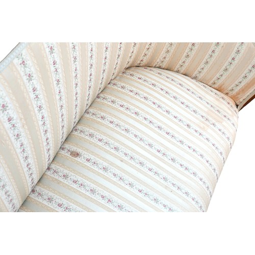 396 - An Edwardian mahogany two seater settee, overstuffed seat upholstered in striped floral fabric, rais... 