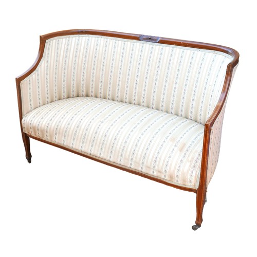 396 - An Edwardian mahogany two seater settee, overstuffed seat upholstered in striped floral fabric, rais... 