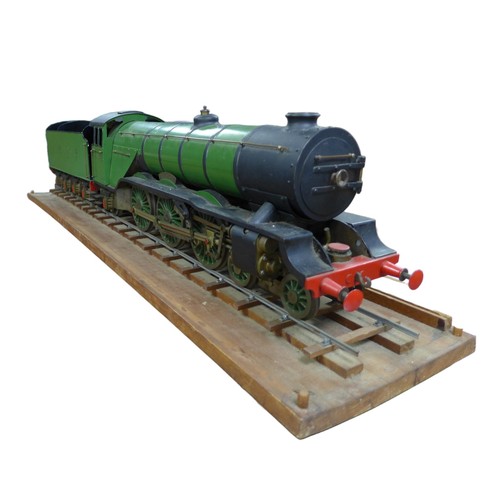 A scratch built L.N.E.R 'Flying Scotsman' locomotive and tender, 2 1/2 gauge, 1/2 scale, 4-6-2, built in the early/mid 1960s, raised on track on wooden plinth, 22 by 107.5cm long, train and tender, 98cm long, together with multiple hand drawn plan copies by Bassett-Lowke Ltd, dated 1954. (2)