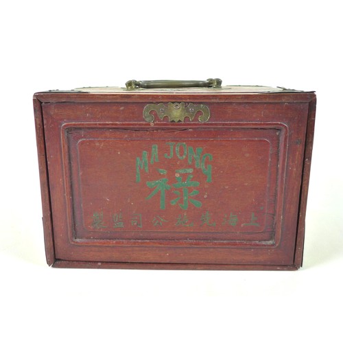 110 - An early 20th century Mahjong set, the case with slide front panel revealing five trays, filled with... 