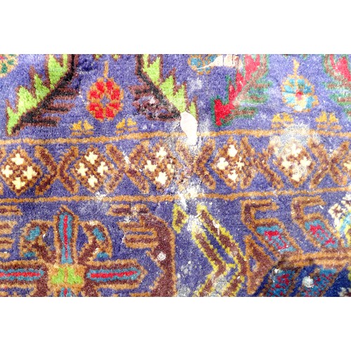 413 - A Persian rug with blue ground, unusual sectional orange and green medallion to the field, blue bord... 