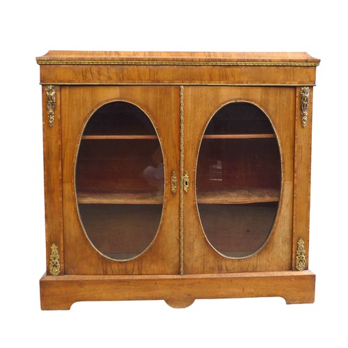 409 - A Victorian walnut veneered pier cabinet, gilt metal mounted, caddy top above two doors with oval gl... 