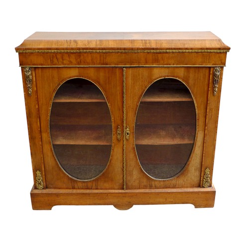 409 - A Victorian walnut veneered pier cabinet, gilt metal mounted, caddy top above two doors with oval gl... 