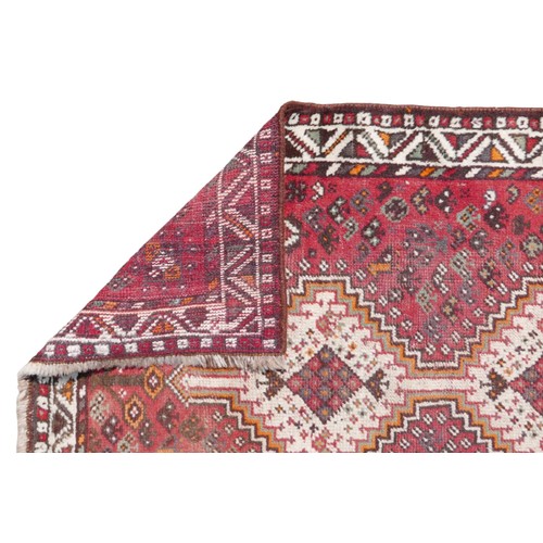 416 - A group of three rugs, comprising a Tekke rug with red ground and eleven offset rows each of twelve ... 