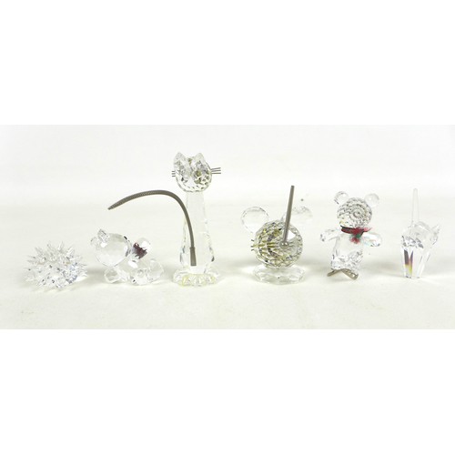 66 - A group of Swarovski crystal animal figurines, comprising a large cat and three small cats, a skatin... 