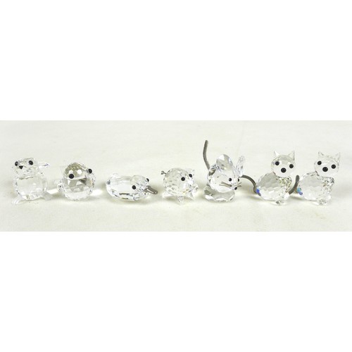 66 - A group of Swarovski crystal animal figurines, comprising a large cat and three small cats, a skatin... 