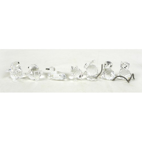 66 - A group of Swarovski crystal animal figurines, comprising a large cat and three small cats, a skatin... 