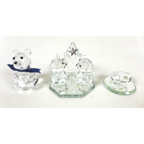 66 - A group of Swarovski crystal animal figurines, comprising a large cat and three small cats, a skatin... 