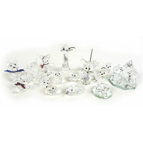 66 - A group of Swarovski crystal animal figurines, comprising a large cat and three small cats, a skatin... 