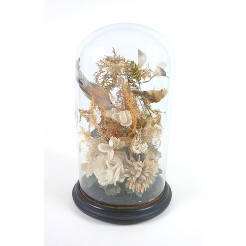 91 - A Victorian style glass dome containing an arrangement of fake birds, within a floral display, 39.5c... 