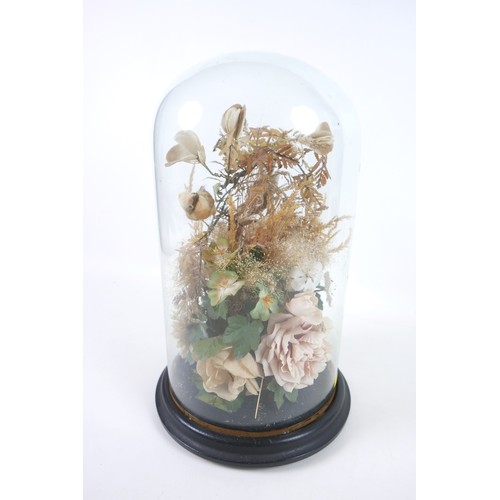 91 - A Victorian style glass dome containing an arrangement of fake birds, within a floral display, 39.5c... 