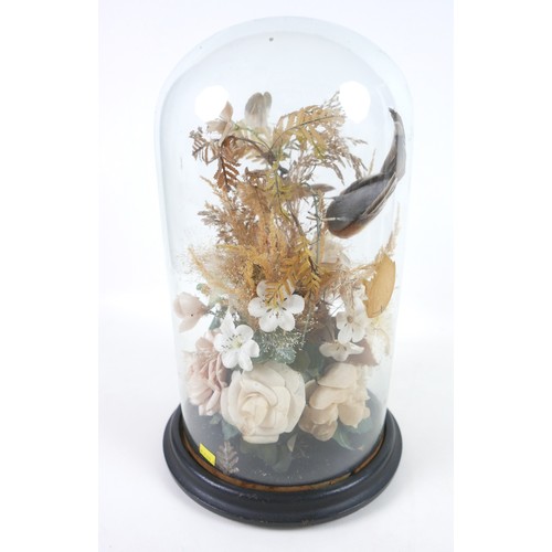 91 - A Victorian style glass dome containing an arrangement of fake birds, within a floral display, 39.5c... 