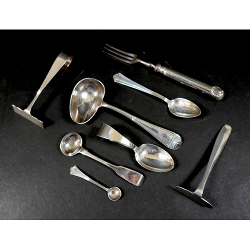 13 - A small group of silver flatware, comprising two baby's food pushers, a feeding spoon, two condiment... 