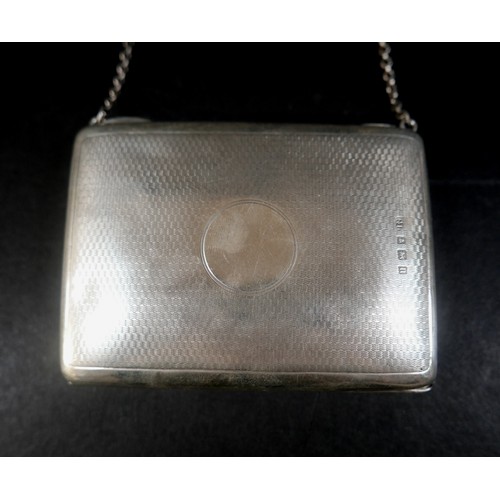 28 - A silver ladies evening bag, with chain and blue silk interior, with machined textured body, and bla... 