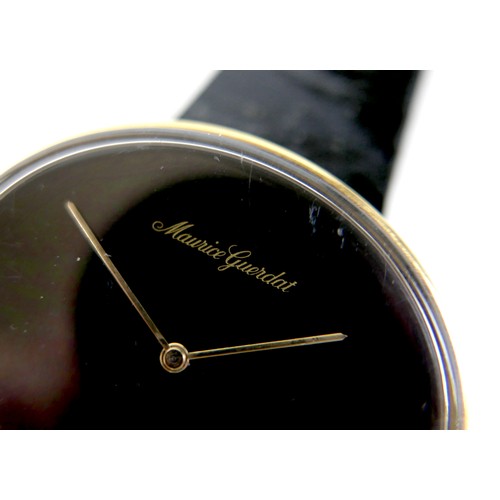 93 - A Maurice Guerdat gold plated lady's dress watch, minimalist oval black dial, gold hands, quartz mov... 