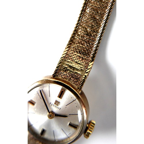 101 - A Tissot 9ct gold lady's wristwatch, circa 1966, with circular silvered dial, gold and black baton c... 