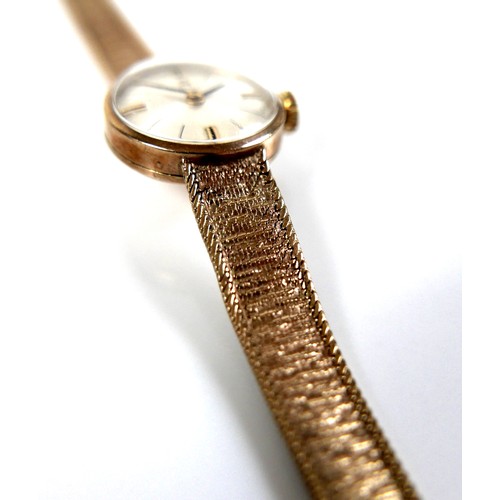 101 - A Tissot 9ct gold lady's wristwatch, circa 1966, with circular silvered dial, gold and black baton c... 