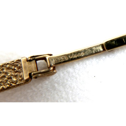 101 - A Tissot 9ct gold lady's wristwatch, circa 1966, with circular silvered dial, gold and black baton c... 