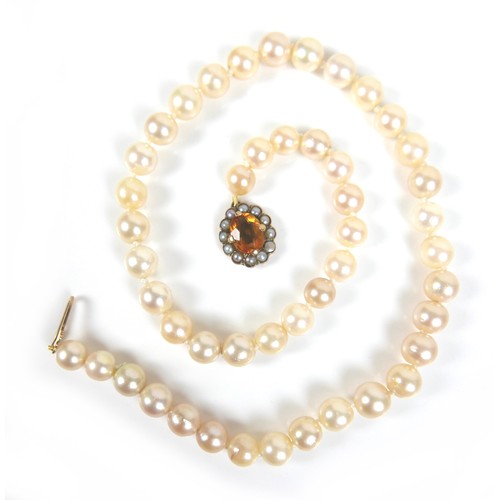 197 - A pearl necklace with 9ct gold citrine and seed pearl clasp, most pearls approximately 7mm diameter,... 