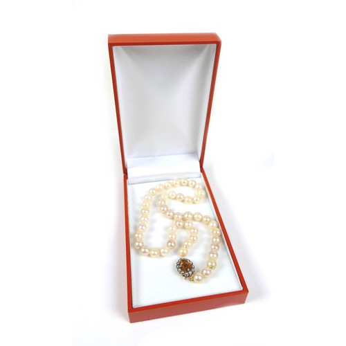 197 - A pearl necklace with 9ct gold citrine and seed pearl clasp, most pearls approximately 7mm diameter,... 