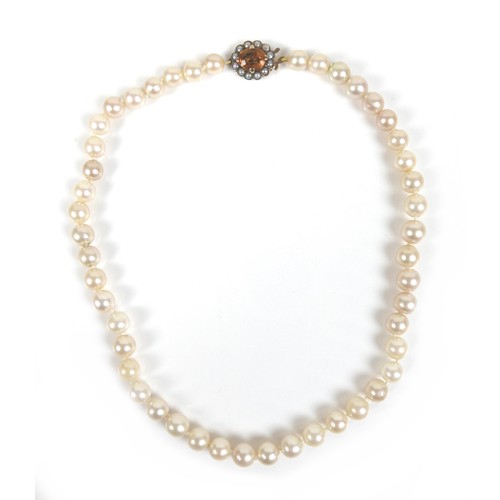 197 - A pearl necklace with 9ct gold citrine and seed pearl clasp, most pearls approximately 7mm diameter,... 